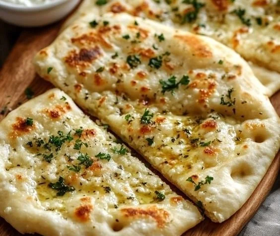 Fluffy cottage cheese flatbread served with toppings on a wooden board